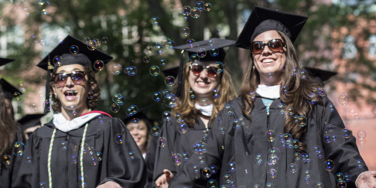 graduates walking through bubbles
