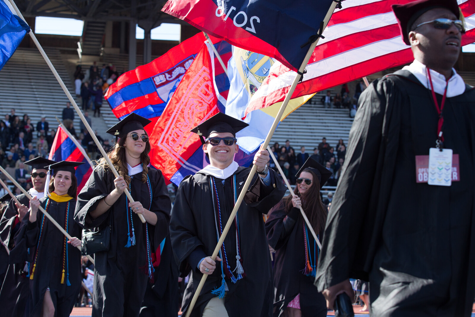 students flagbearers entering Franklin Field 