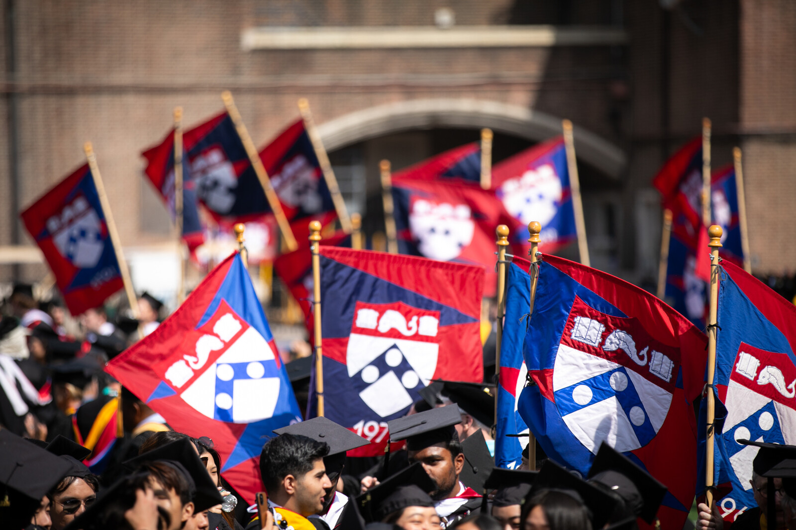 procession of graduates and flags