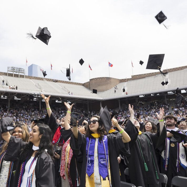 graduates tossing caps